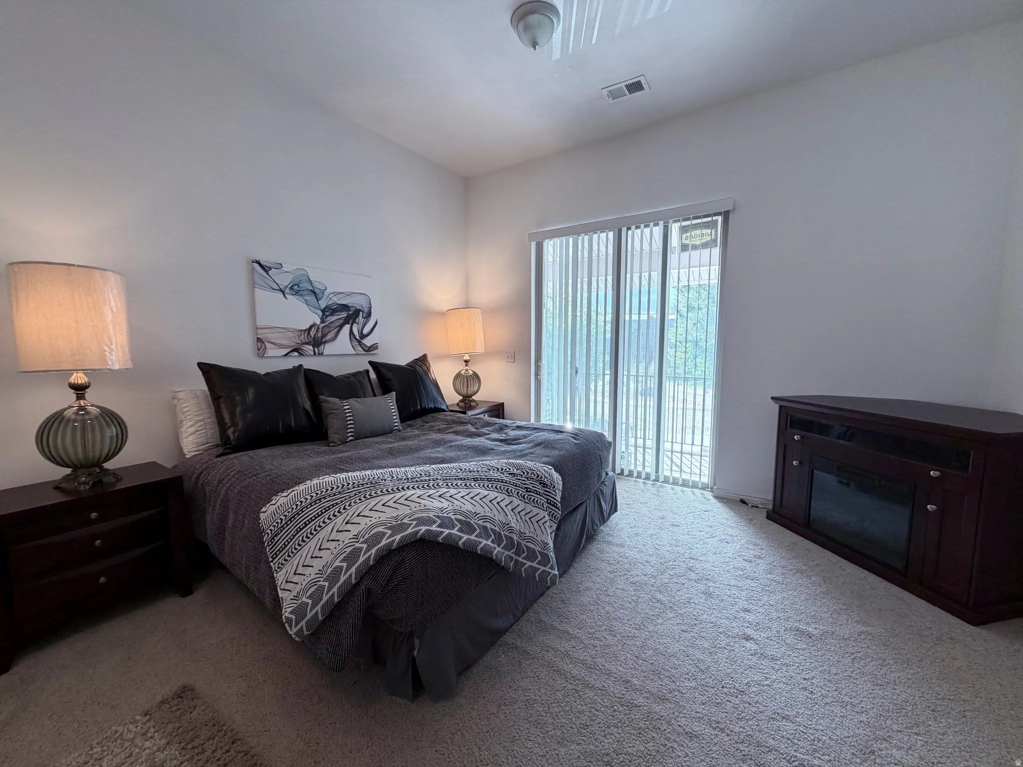 Carpeted bedroom featuring access to exterior