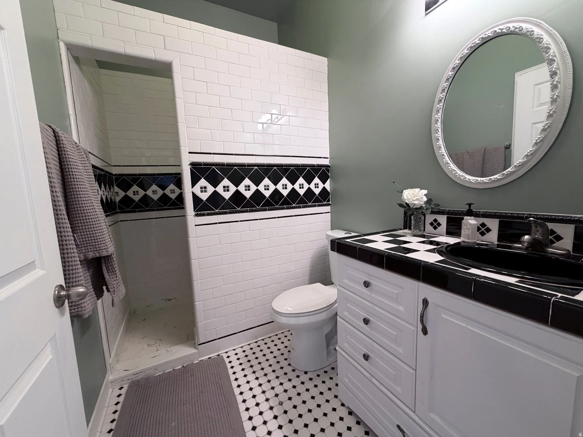 Bathroom with vanity and a tile shower