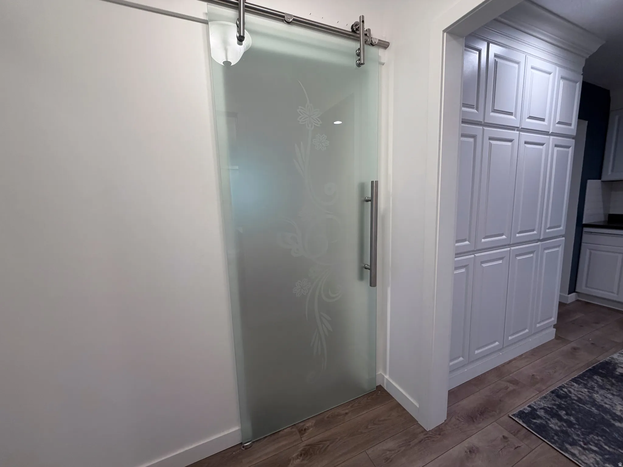 Full bathroom featuring dark wood finished floors and a shower stall