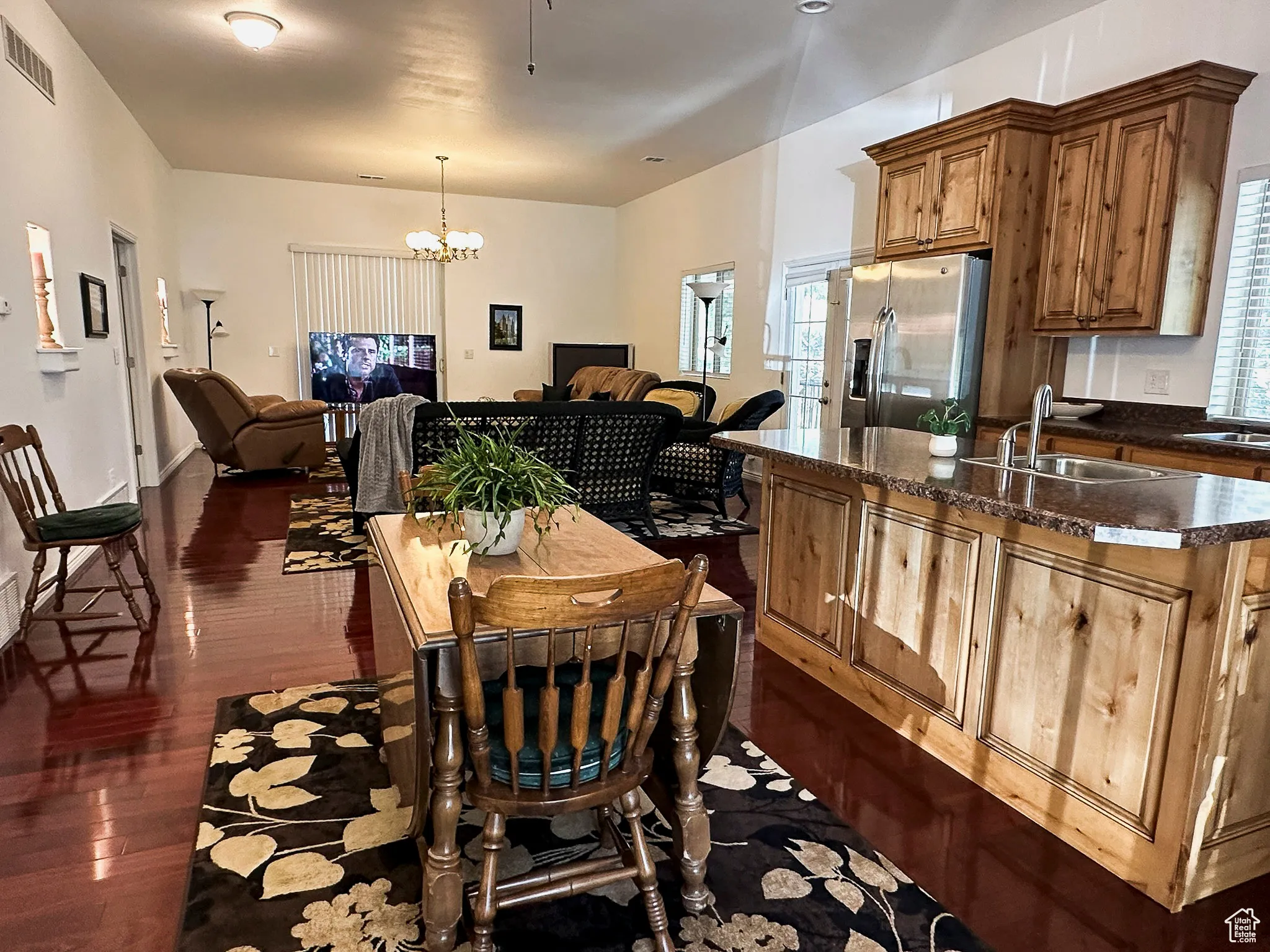 ADU - Dining space with dark wood-style floors and a chandelier