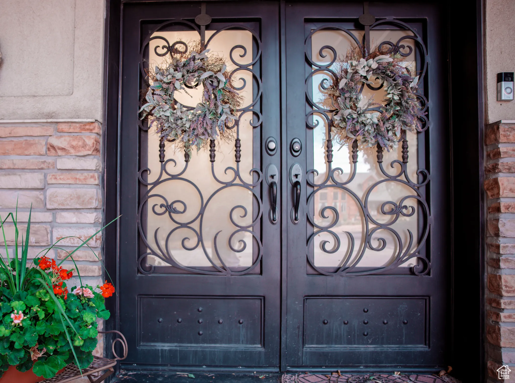 Property entrance featuring brick siding