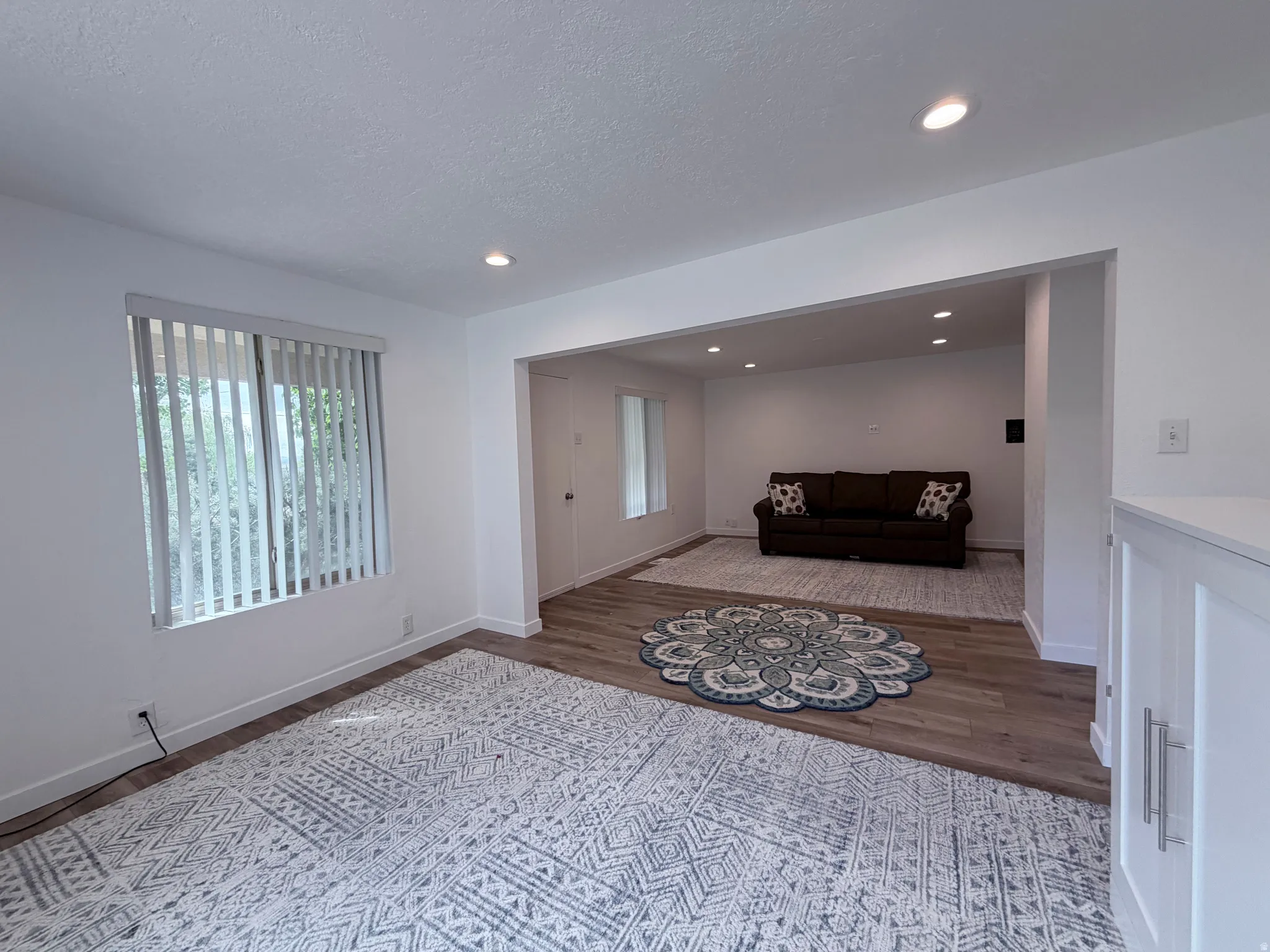 Sitting room featuring dark wood-style floors, recessed lighting, and a textured ceiling