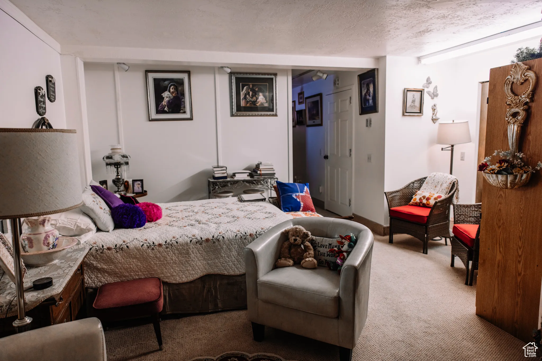 Carpeted bedroom with a textured ceiling and a closet