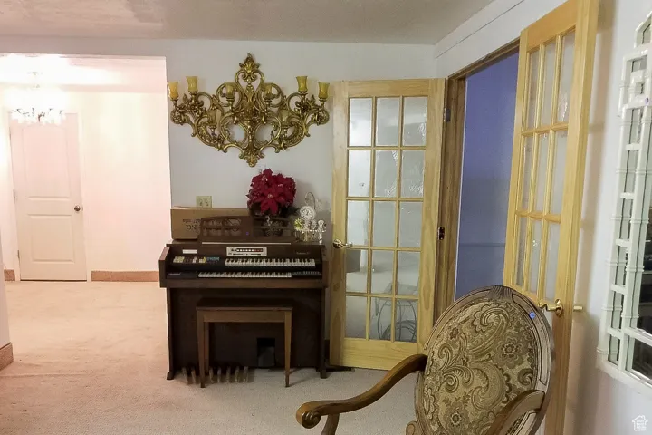 Living area with carpet floors and a chandelier