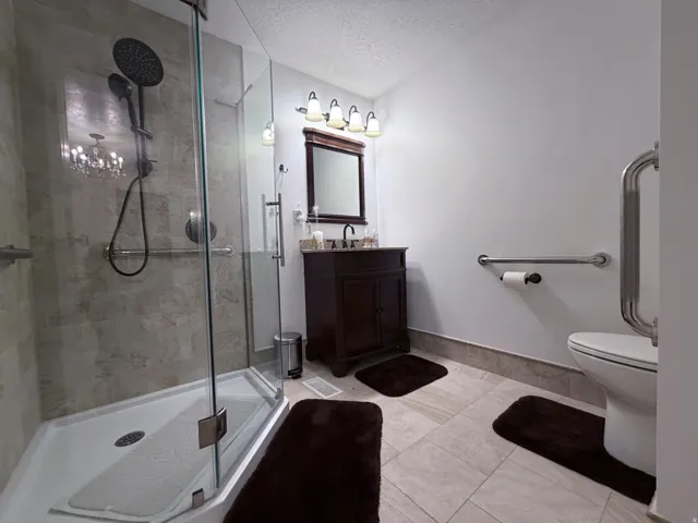 Bathroom with vanity, a textured ceiling, and a shower stall