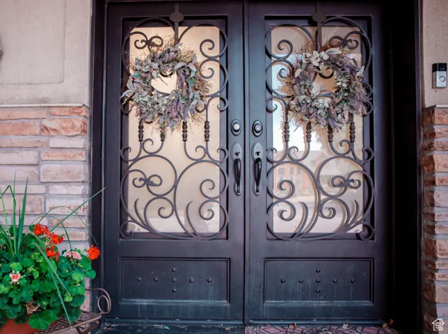 Property entrance featuring brick siding