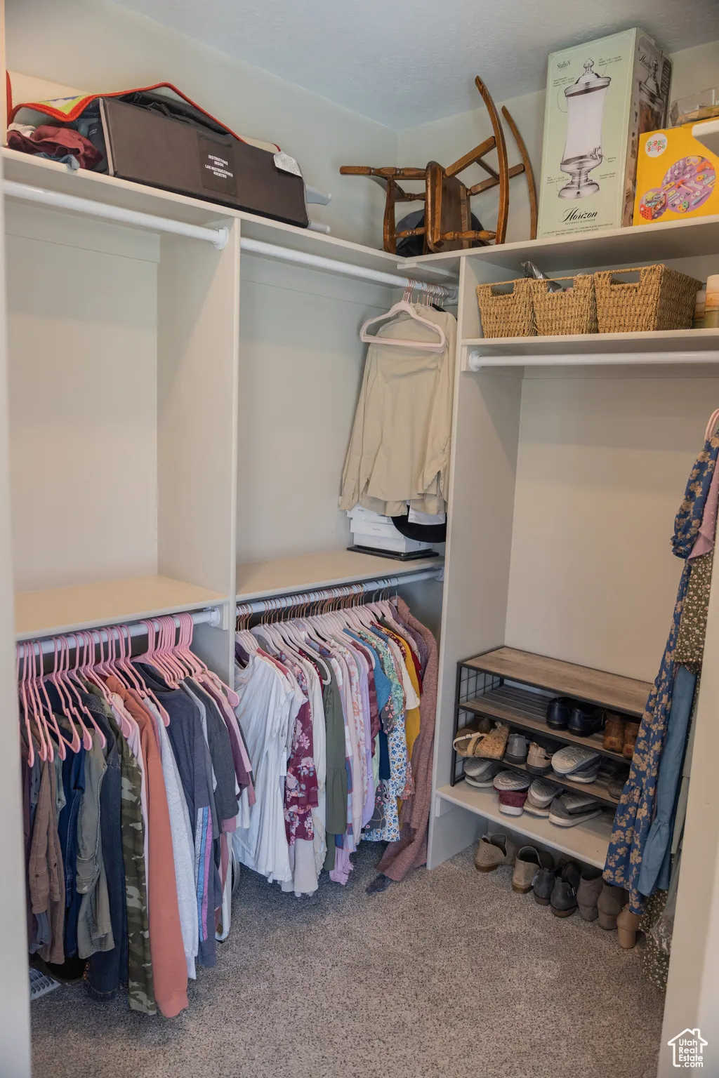 Spacious master closet featuring carpet flooring