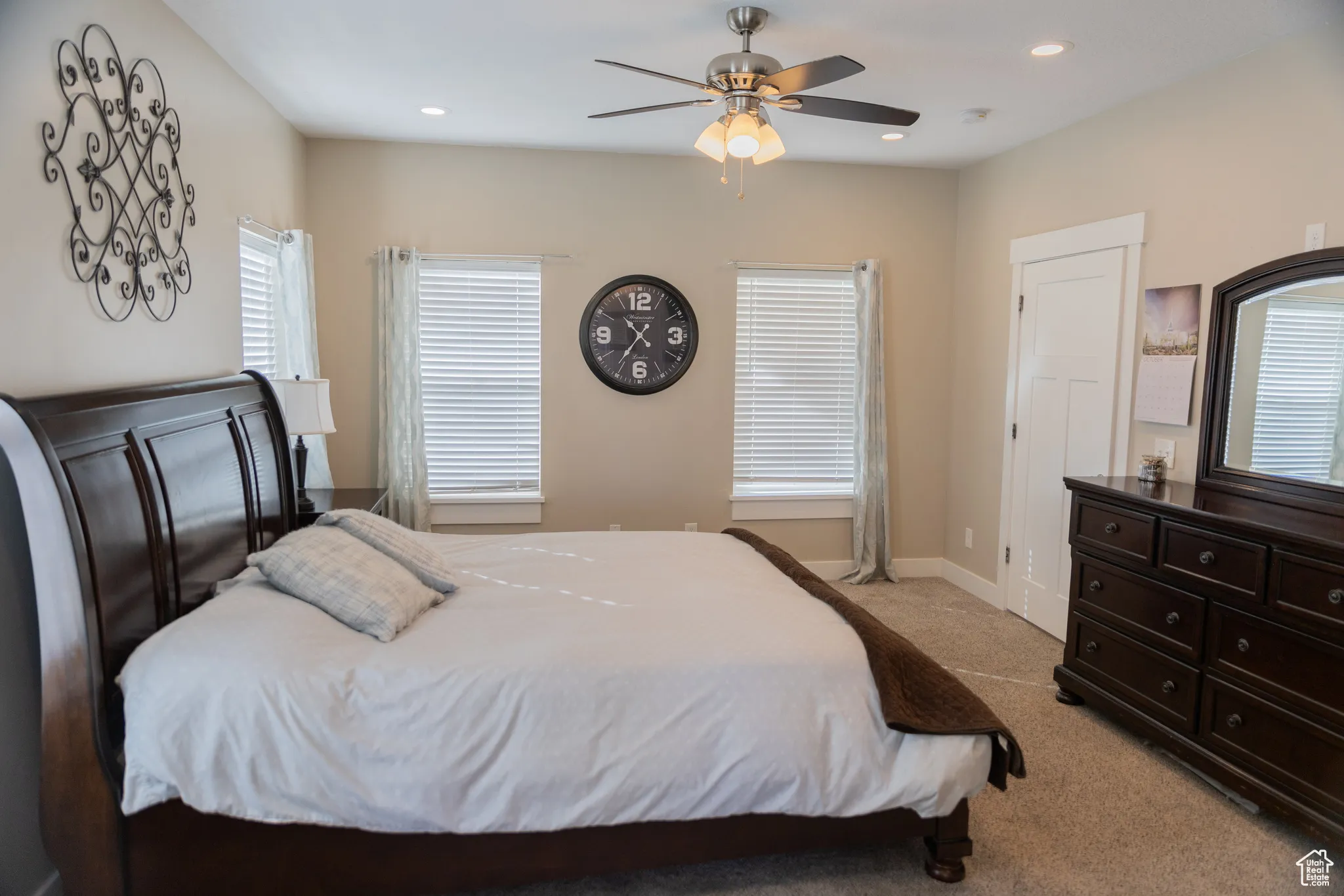 Master bedroom featuring light carpet, a ceiling fan, and recessed lighting and ensuite bathroom