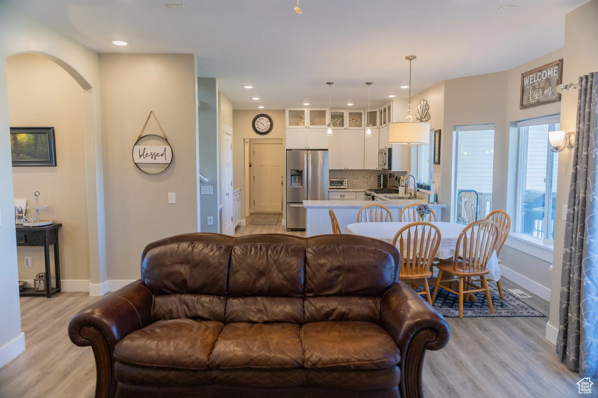 Living area with recessed lighting and light wood LVP floors