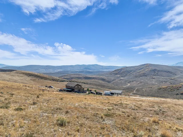 View of mountain background featuring rural landscape