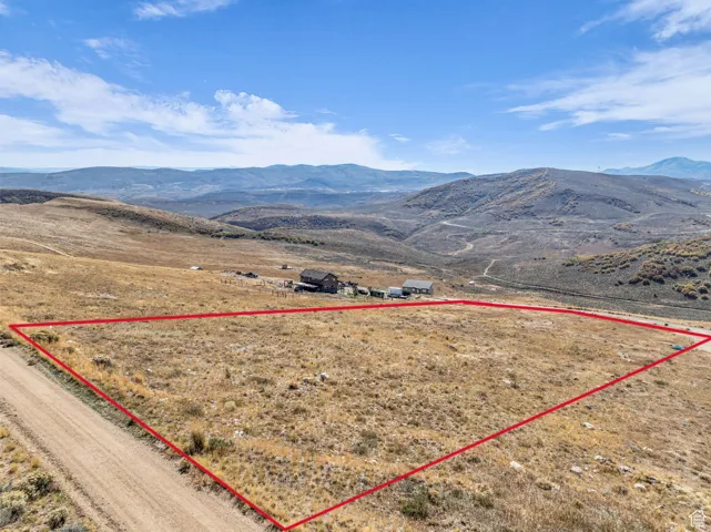 Overview of rural landscape with a mountainous background and property parcel outlined