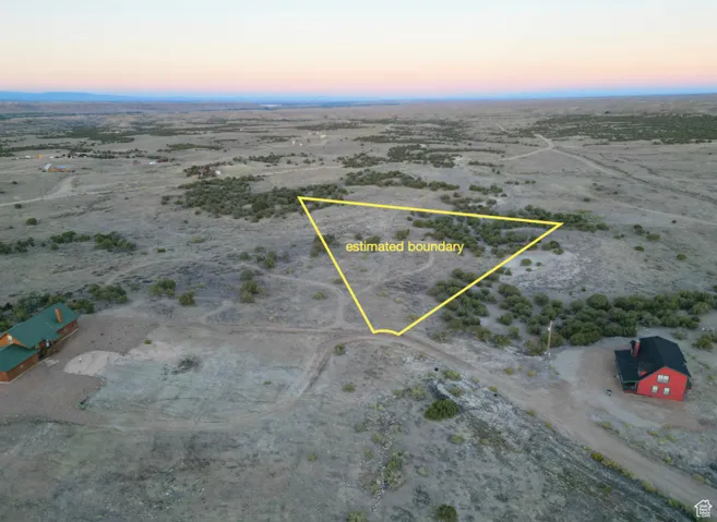 Aerial view at dusk of a view of countryside, view of desert landscape, and property boundaries highlighted