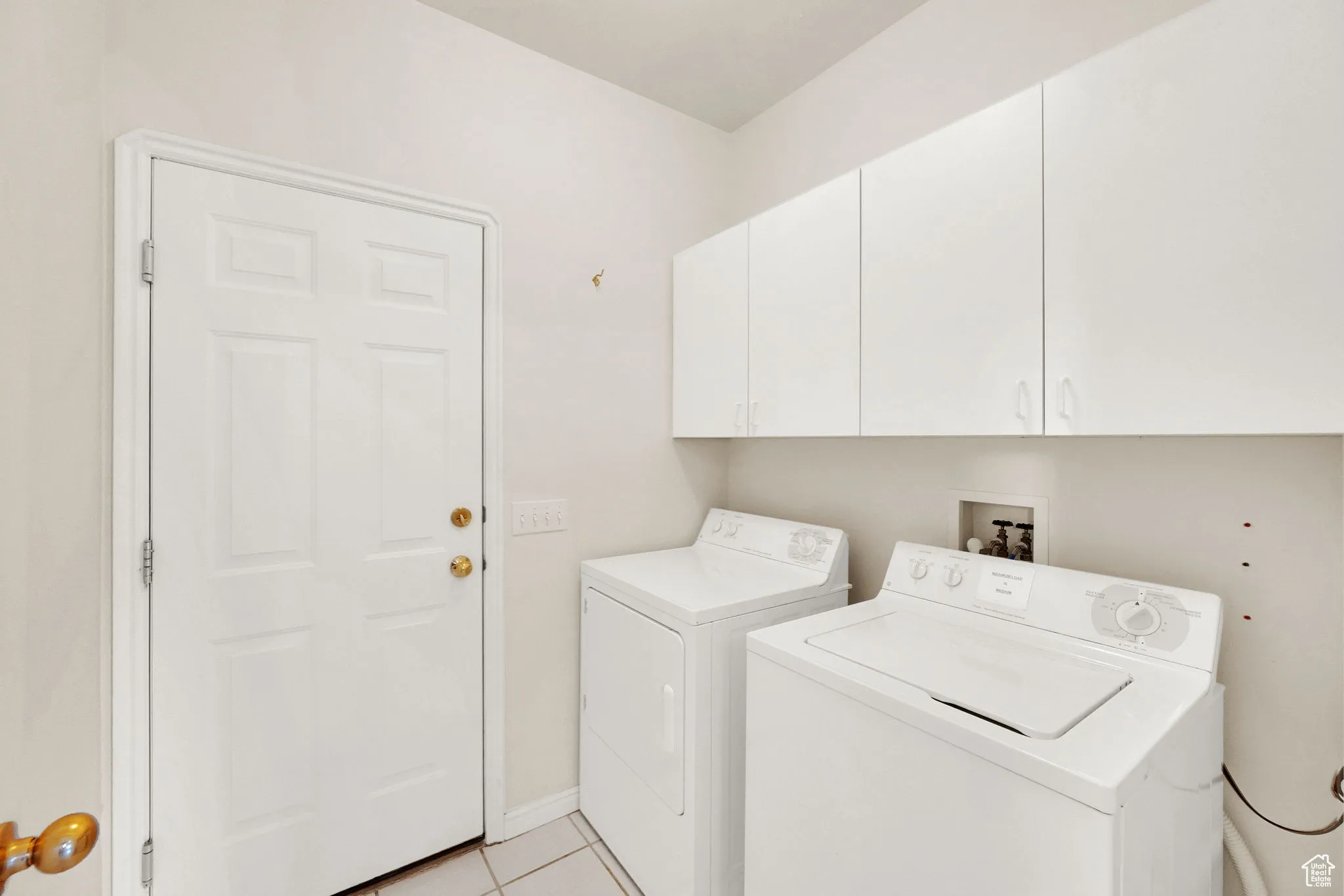 Laundry area with door to garage near kitchen.
