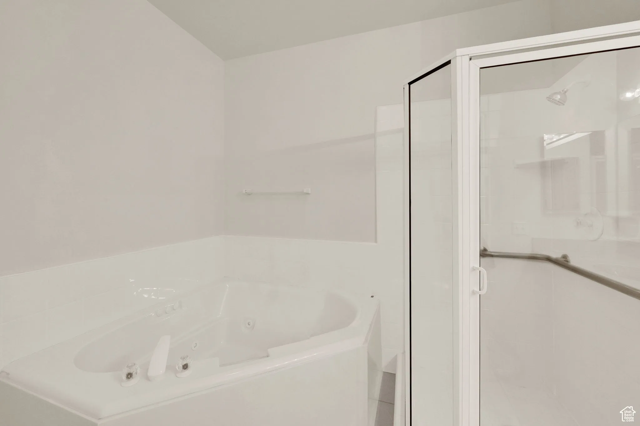 Mater bathroom with a jetted tub and a shower stall.