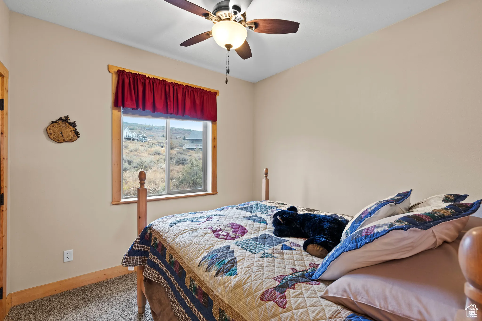Bedroom featuring a ceiling fan and carpet floors