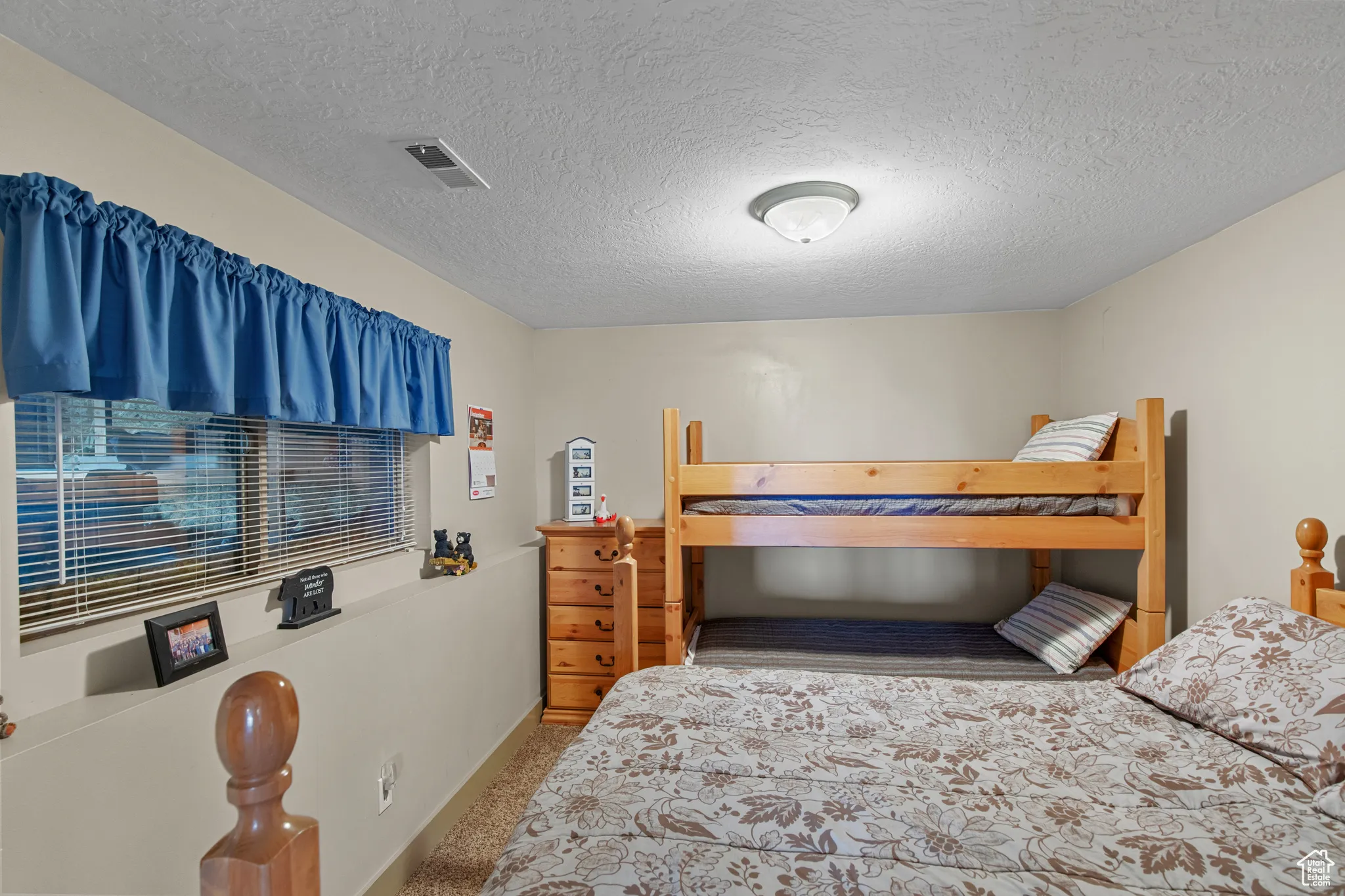 Bedroom with carpet floors and a textured ceiling
