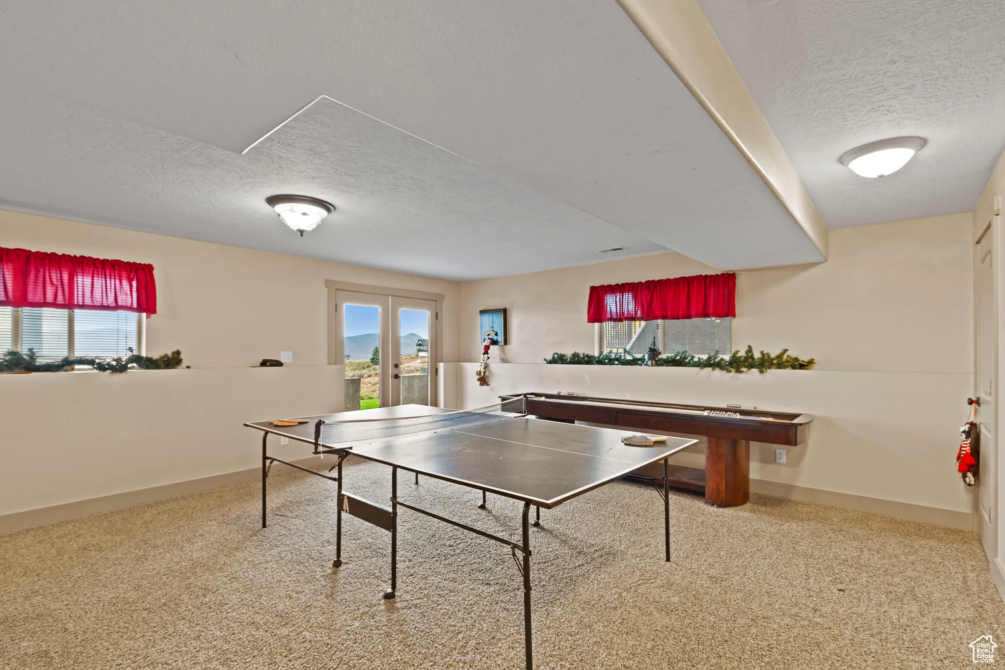 Recreation room featuring a textured ceiling and french doors