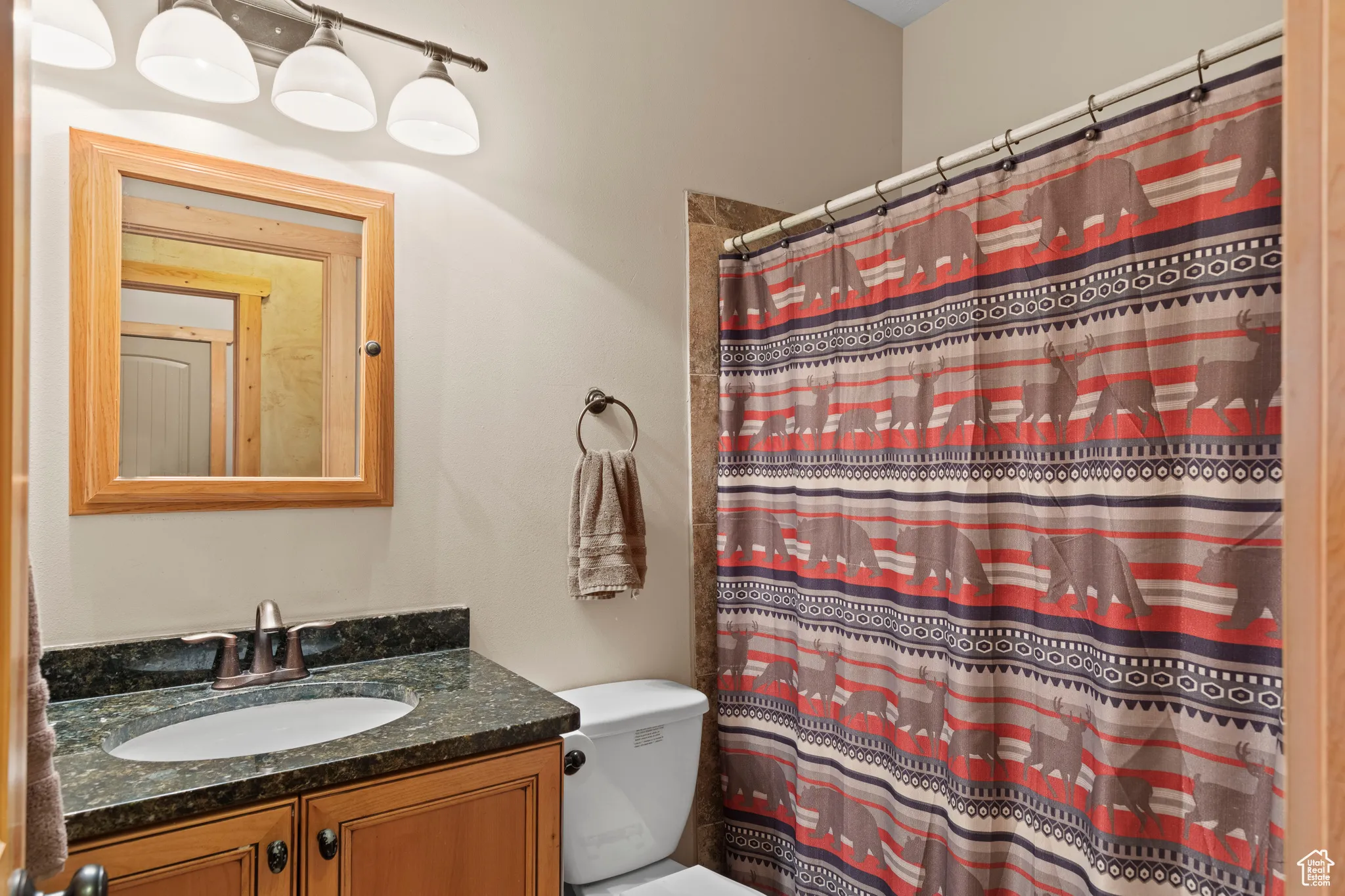 Full bathroom with vanity and curtained shower
