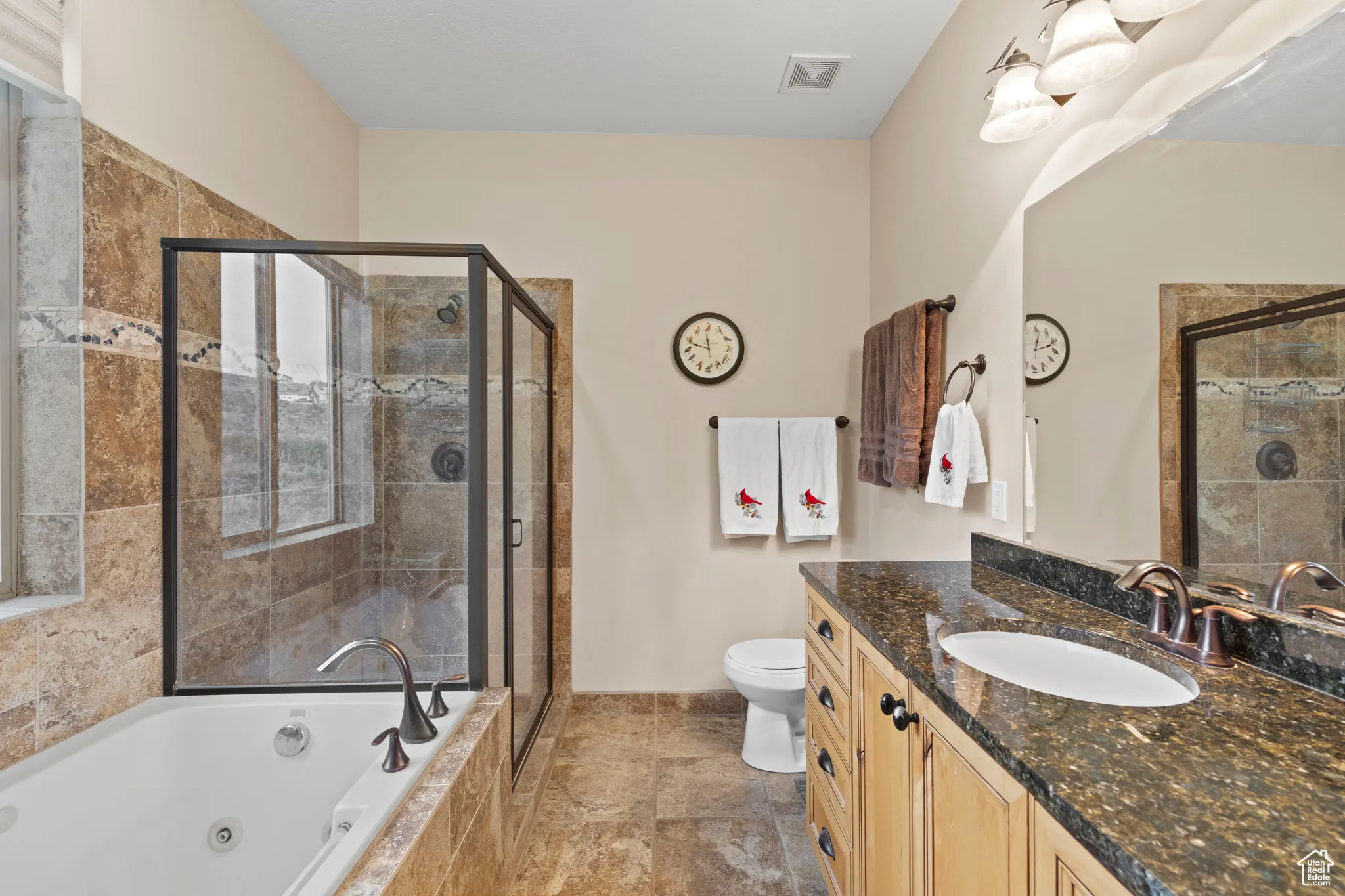 Full bathroom with vanity, a whirlpool tub, and a stall shower