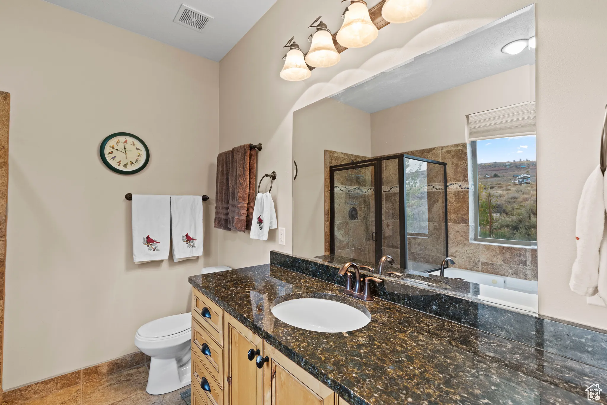 Full bath featuring vanity, a stall shower, and a garden tub