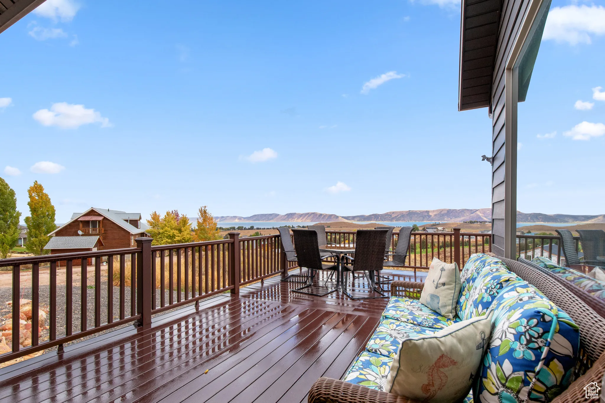 Wooden deck with a mountain view and outdoor dining area
