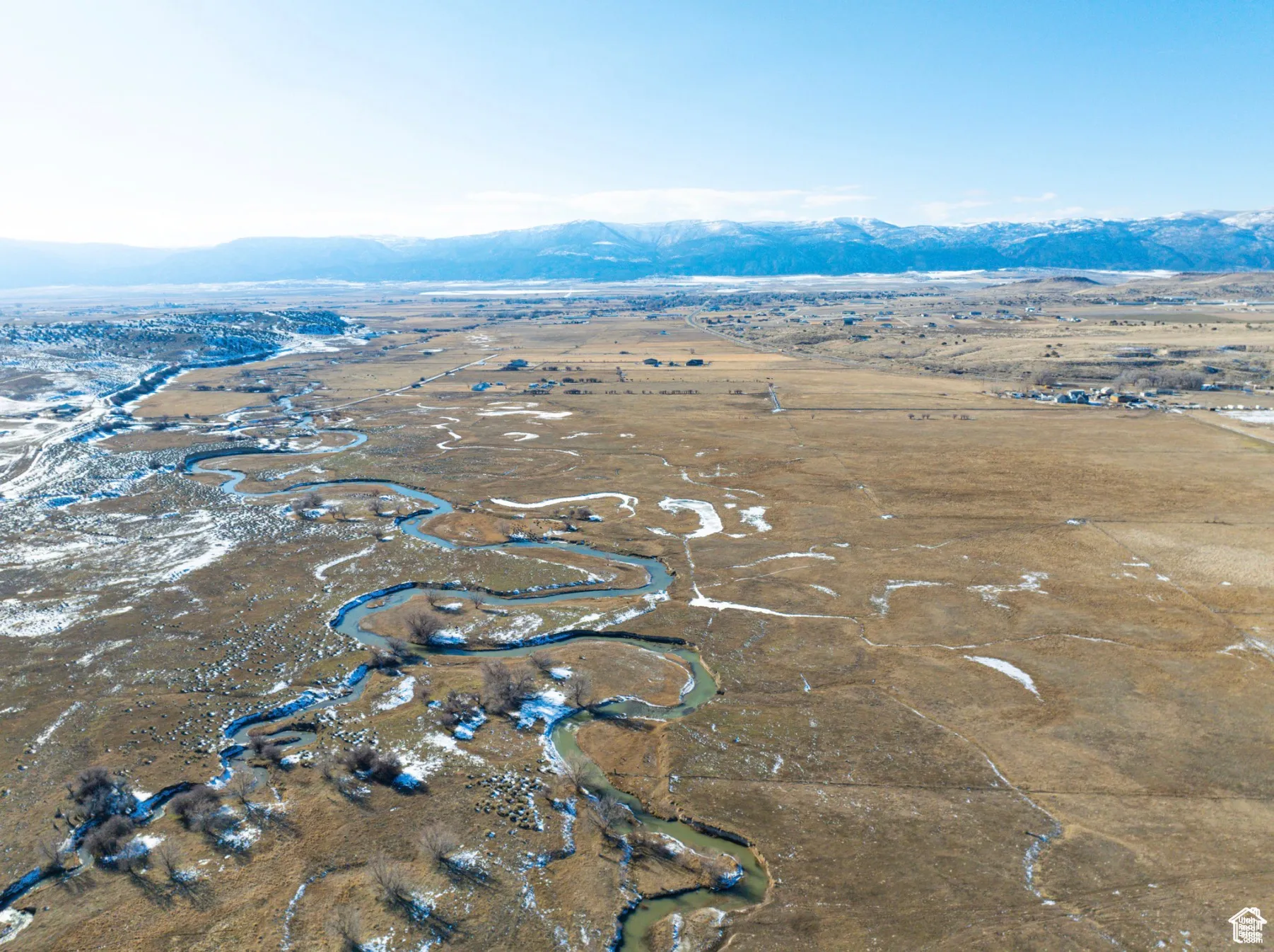 Aerial view of property's location with a mountainous background and rural landscape