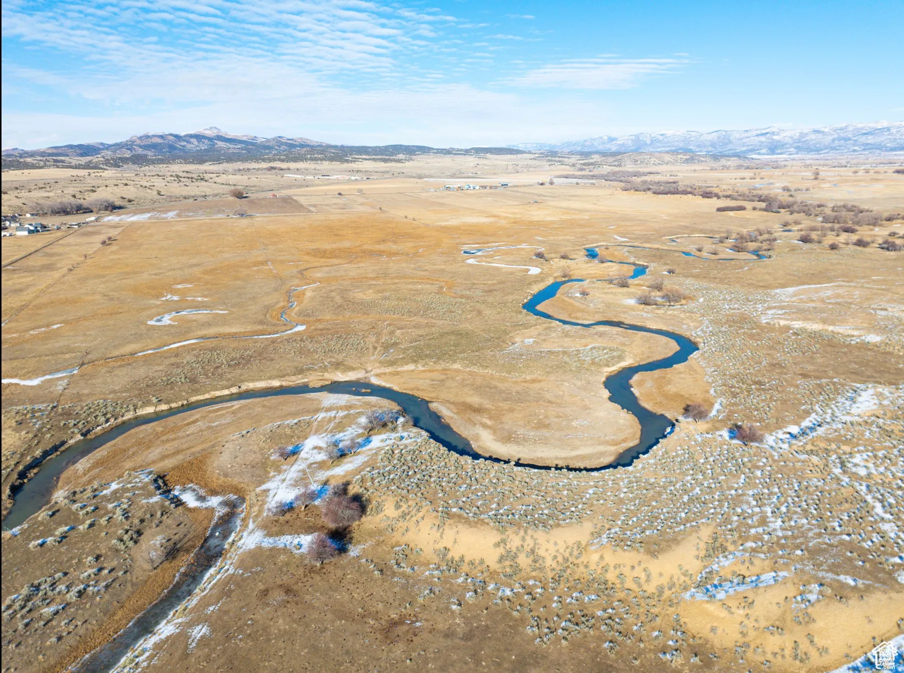 Aerial overview of property's location featuring a mountain backdrop and rural landscape