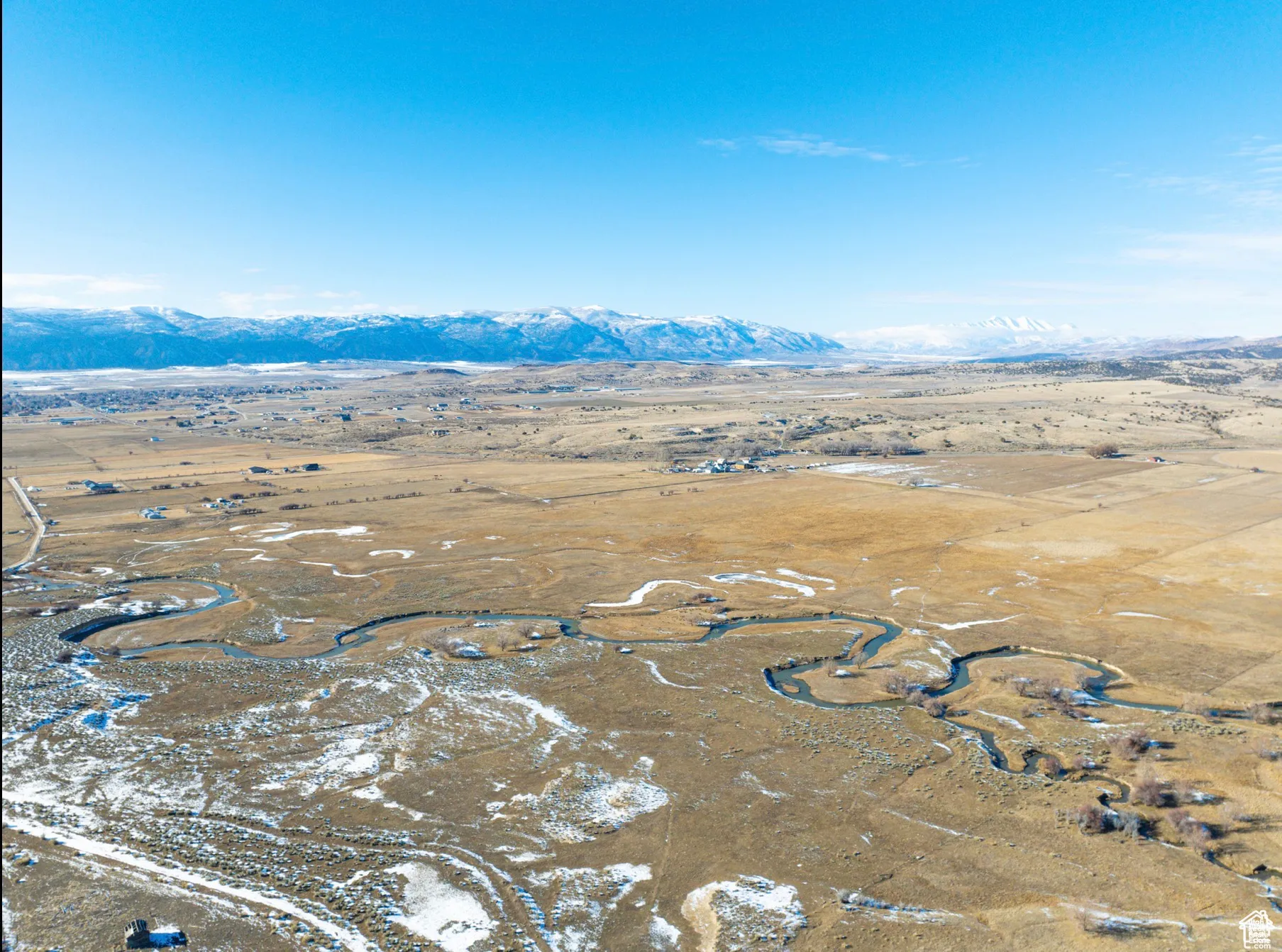 Aerial overview of property's location with a mountain backdrop and rural landscape