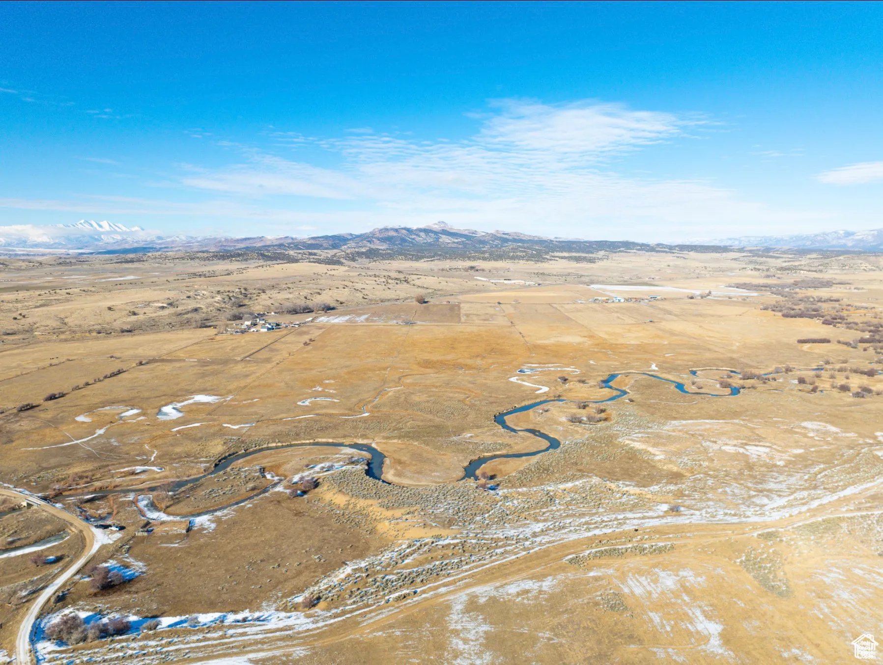 Aerial view of property's location with a mountainous background and rural landscape