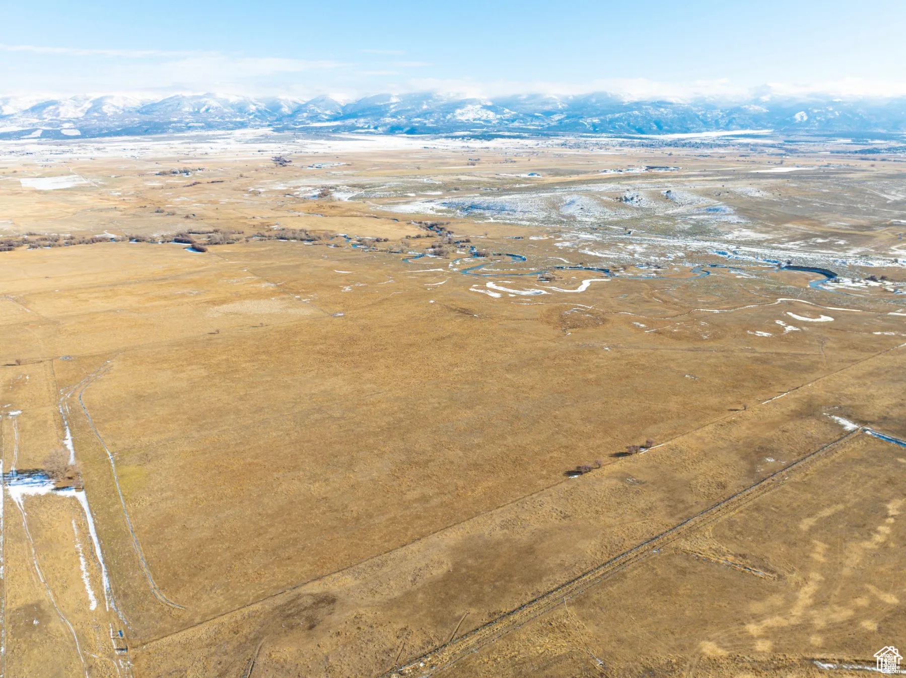 Aerial view of sparsely populated area featuring a mountainous background and a desert landscape