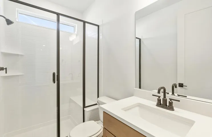 Full bathroom with vanity and a shower stall