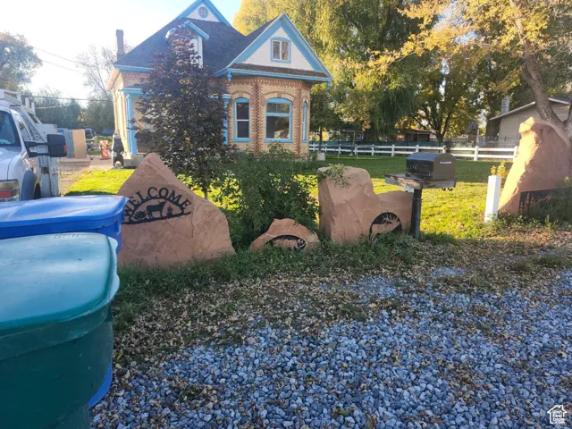 View of front of home with brick siding and a shingled roof