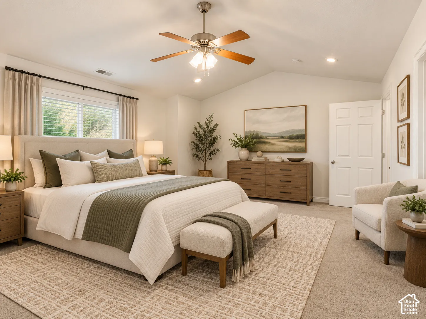 Vaulted ceilings with a central ceiling fan and neutral carpeting