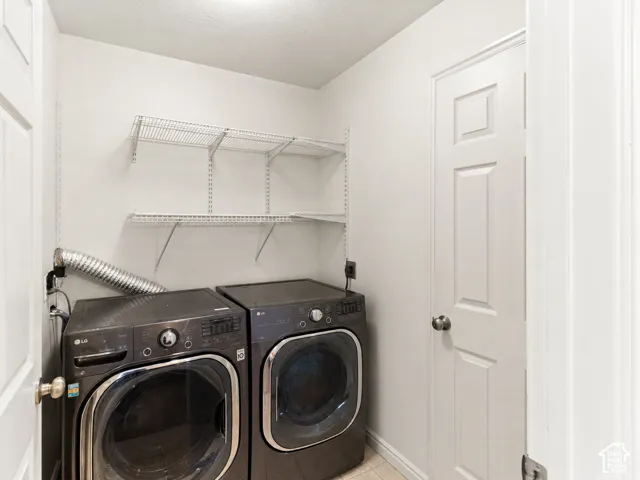 Laundry space featuring white walls, a six-panel interior door, and adjustable wall-mounted wire shelving