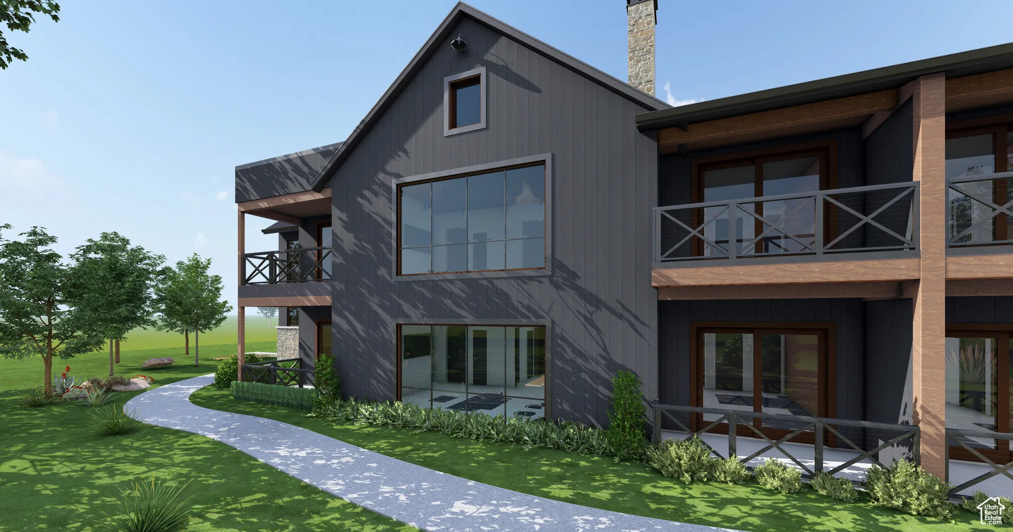 Rear view of house featuring a balcony, a chimney, and a yard