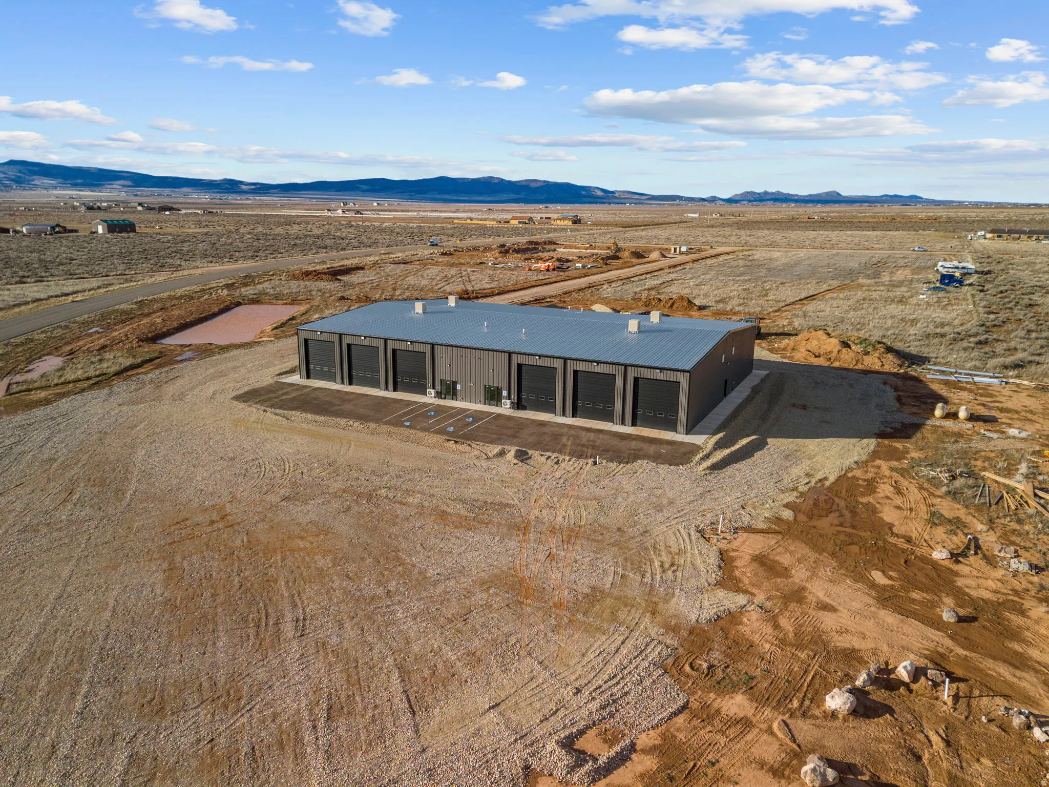 Aerial view of sparsely populated area with a mountain backdrop and a desert landscape
