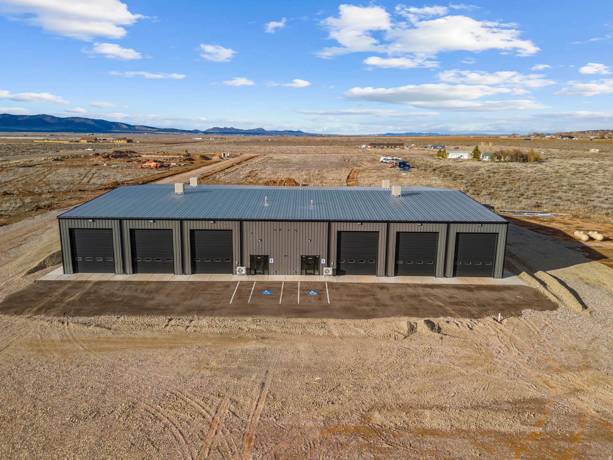 View of outdoor structure featuring a desert view, a mountain view, and a view of rural / pastoral area
