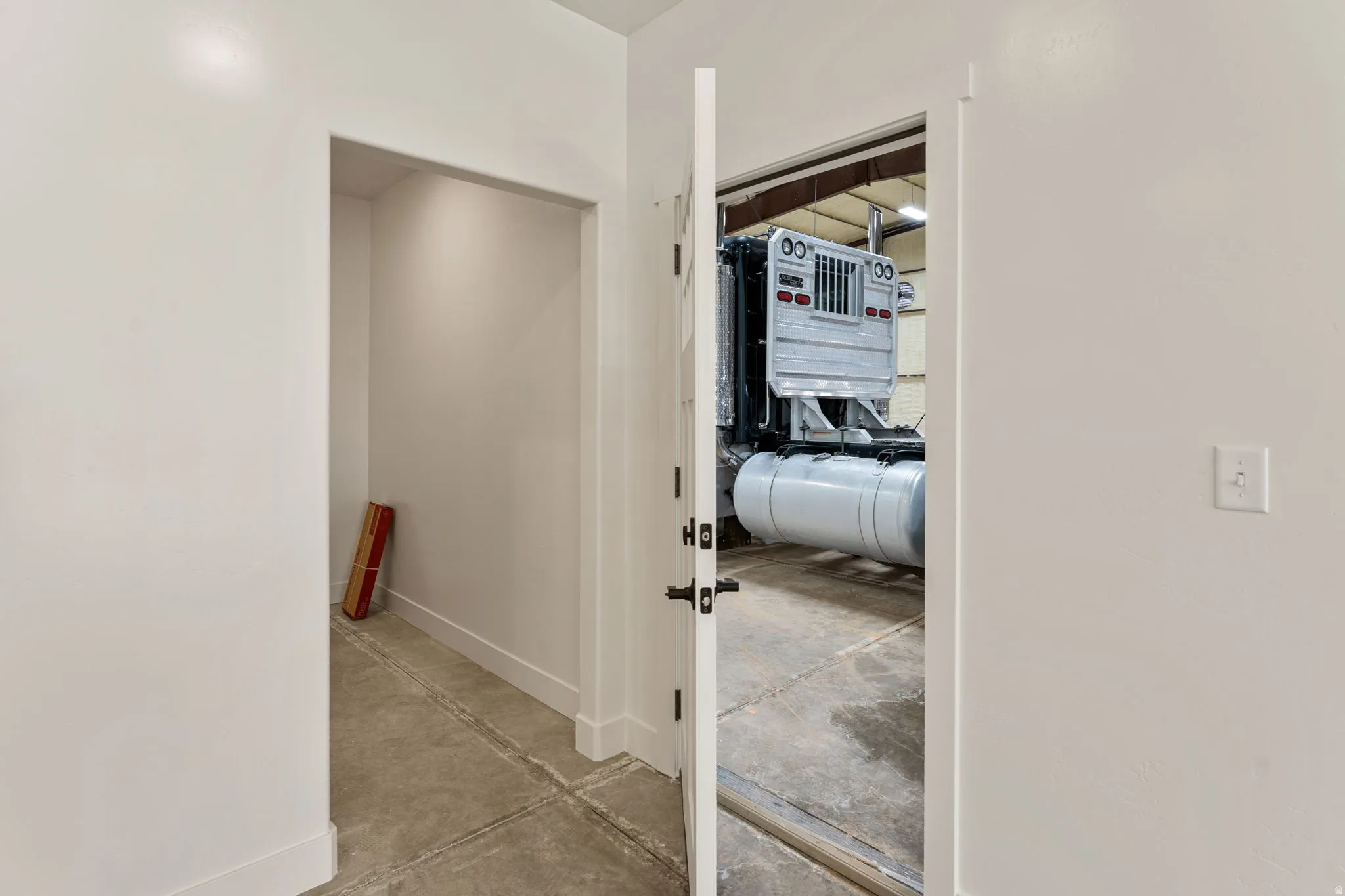 Hall featuring concrete floors and baseboards