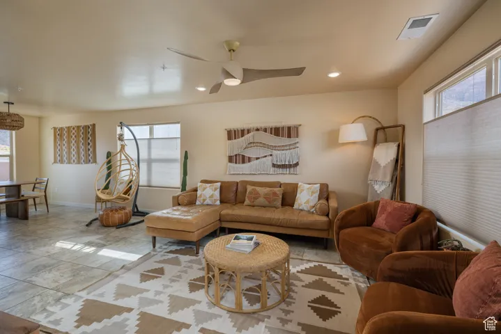 Living area featuring a ceiling fan and recessed lighting