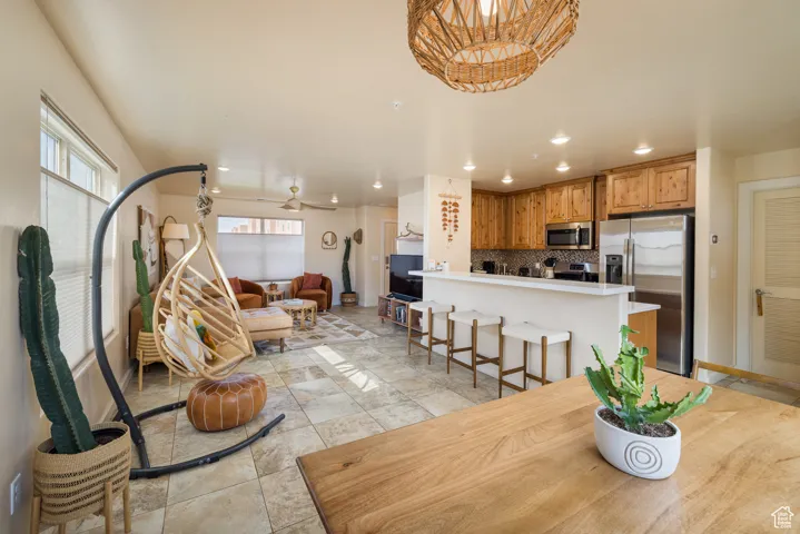 Dining space featuring a ceiling fan, recessed lighting, and light tile patterned floors