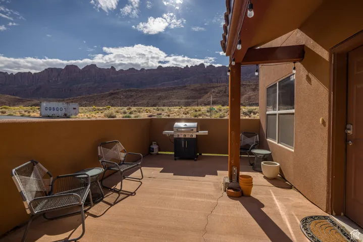 View of patio / terrace with grilling area and a mountain view