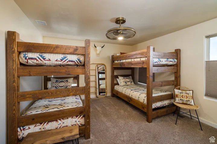 Bedroom featuring carpet floors and baseboards