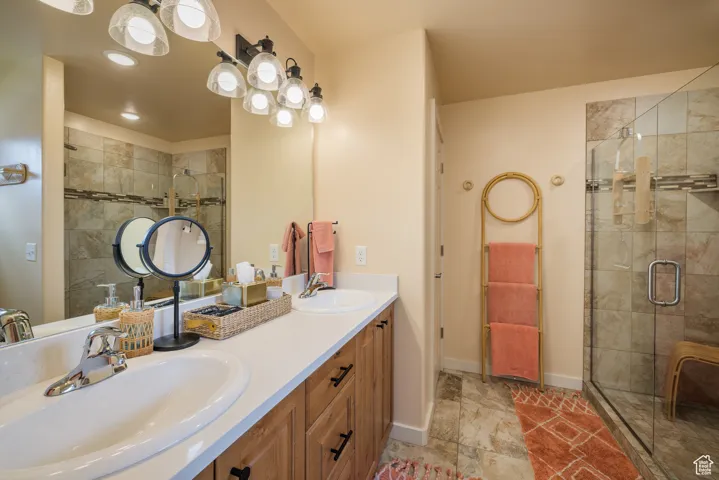 Bathroom with double vanity and a shower stall