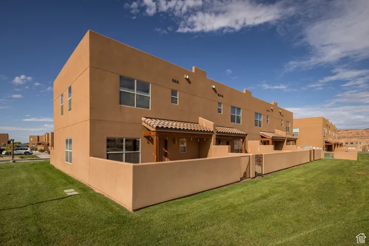 Rear view of house with stucco siding and a residential view