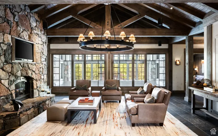 Living room with a stone fireplace, a wood ceiling with exposed beams, stone tile floors, a chandelier, and high vaulted ceiling