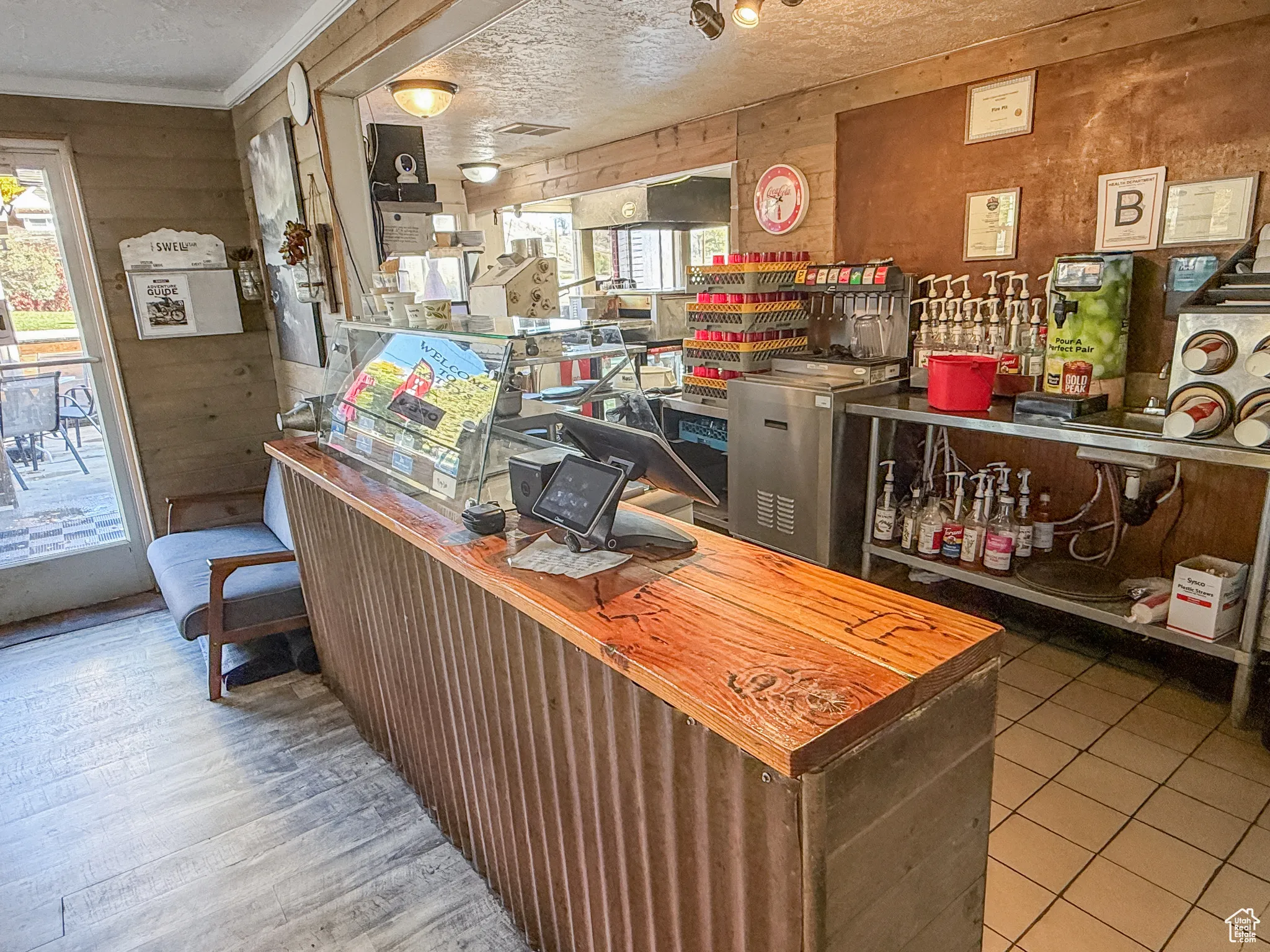 Office space with wood walls and a textured ceiling
