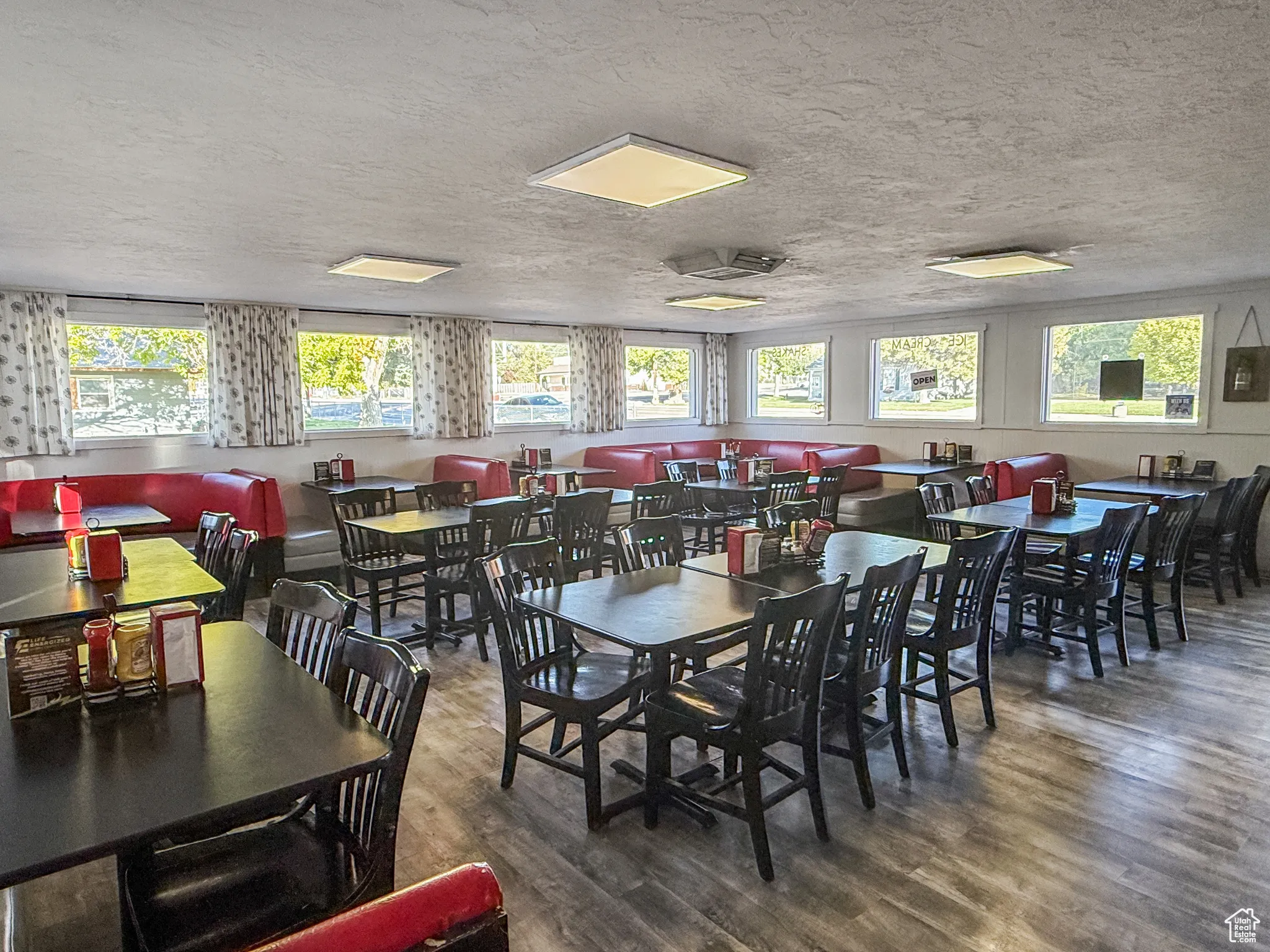 Dining room with wood finished floors and a textured ceiling