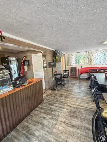 Kitchen featuring wood walls, a textured ceiling, and butcher block counters