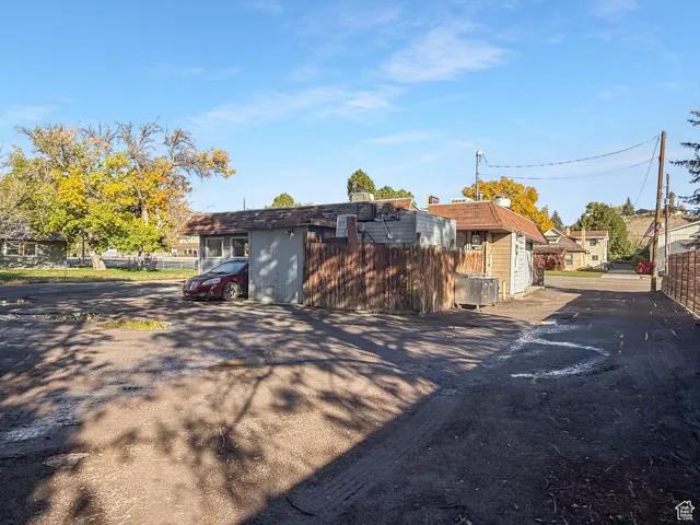 Rear view of property with driveway