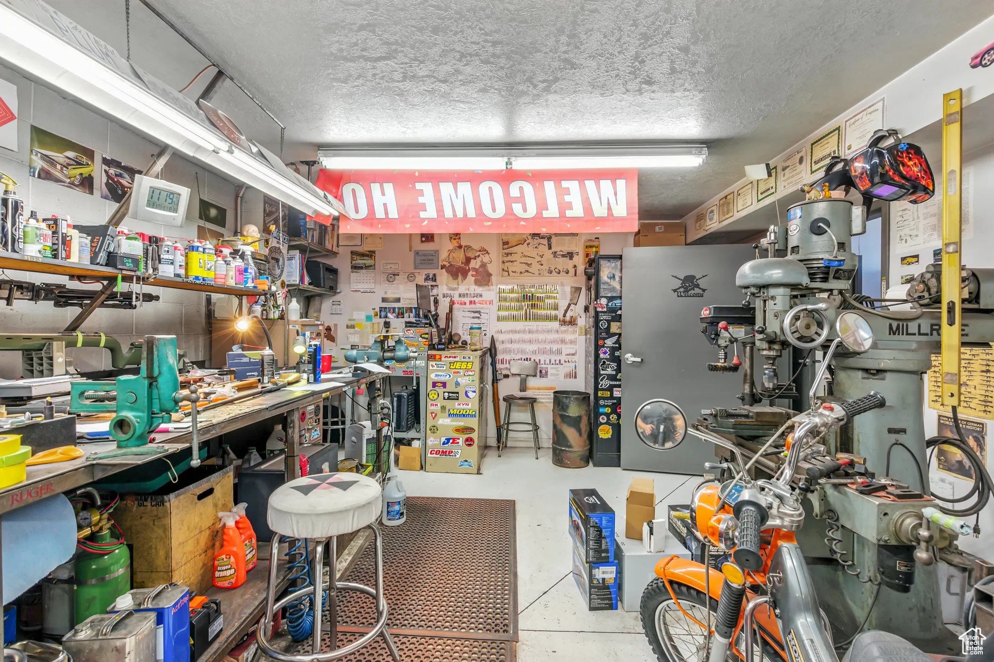 Miscellaneous room featuring a workshop area and a textured ceiling